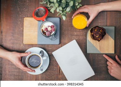 Close view of hands taking food and drink - Powered by Shutterstock