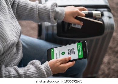 close up of view hands women holding smartphone display on app mobile vaccinated COVID-19 or coronavirus certificate, immunity vaccine passport, new normal travel of tourist concept.