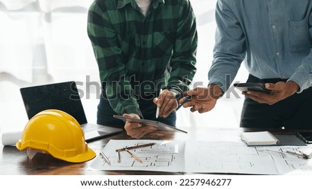 Close up view of hands working brainstorming and measuring for cost estimating on paperworks and floor plan drawings about design architectural and engineering for houses and buildings.
