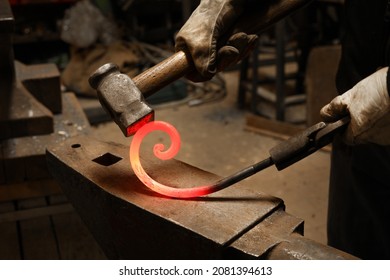 Close up view of heated metal and anvil. The blacksmith in the production process of metal products handmade in the forge. Blacksmith forging metal with a hammer. - Powered by Shutterstock