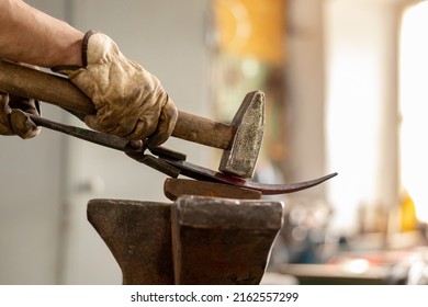 Close up view of heated metal and anvil. The blacksmith in the production process of metal products handmade in the forge. Blacksmith forging metal with a hammer. Metal industry, old profession. - Powered by Shutterstock