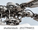 Close up view of a helicopter rotor head showing the mechanical detail of the blades