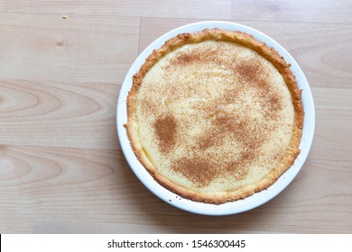 A close up view of home made fresh chilled milk tart on a wood counter waiting to be eaten  - Shutterstock ID 1546300445