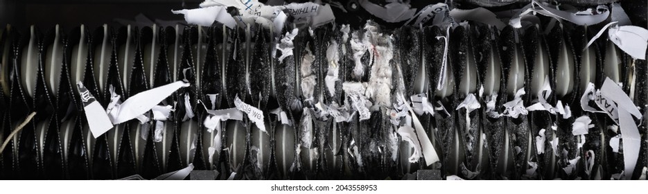 Close Up View Of Home Paper Shredder Teeth Jammed With Shredded Paper