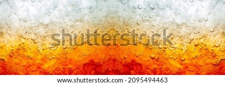 Close up view of the ice cubes in dark cola background. Texture of cooling sweet summer's drink with foam and macro bubbles on the glass wall. Fizzing or floating up to top of surface

