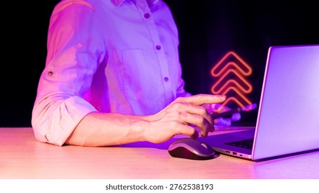 Close view of interactive tech session with pointing hand, laptop, and glowing upload arrows hologram over gadget in low light