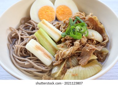 Close Up View Of Japanese Beef Soba Noodles Served With An Egg And Spring Onions.