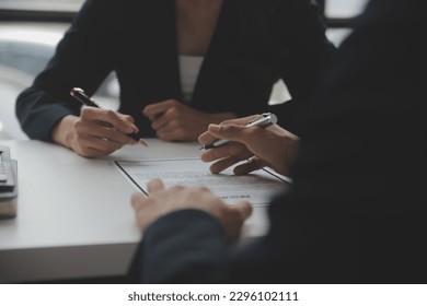 Close up view of job interview in office, focus on resume writing tips, employer reviewing good cv of prepared skilled applicant, recruiter considering application, hr manager making hiring decision - Shutterstock ID 2296102111