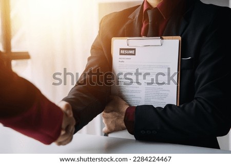 Close up view of job interview in office, focus on resume writing tips, employer reviewing good cv of prepared skilled applicant, recruiter considering application, hr manager making hiring decision