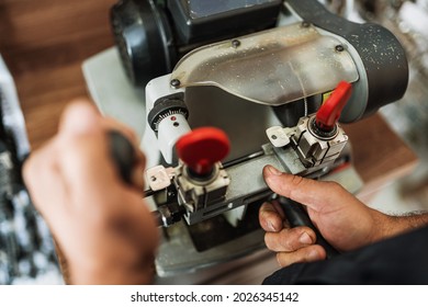 Close view of key copying machine with key. Duplicate machine make new key. Locksmith theme. Blank keys for cutting. Black modern car door opener.