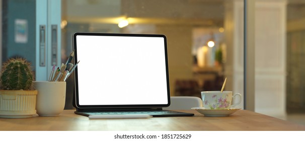 Close up view of of laptop, coffee cup and copy space on wooden table in home office, include clipping path - Shutterstock ID 1851725629