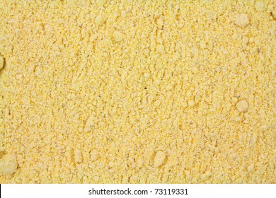 Close View Of A Layer Of Stone Ground Yellow Corn Meal.