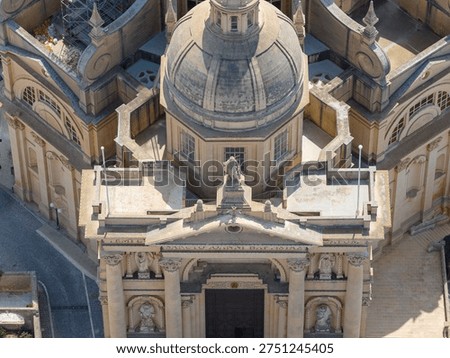 Close view of the limestone dome and upper facade of the Xewkija Rotunda, Church of St John the Baptist, with lantern, balustrades and carved details.