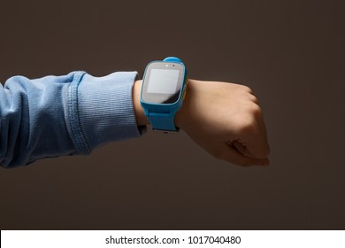 Close Up View Of Little Boy Hand With Smartwatch. Wearable Children Tracking Gadget With Touch Screen And Calling Service, Electronic Wristband For Children