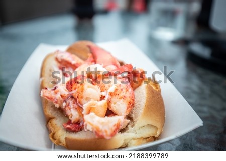 Close up view of a lobster roll with butter