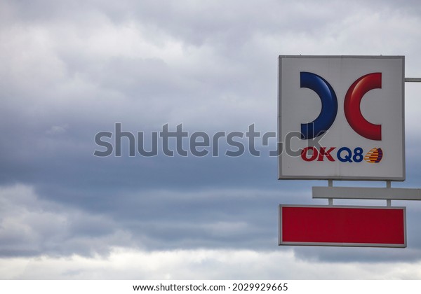Close up view\
of logotype board of well-known gas station OKQ8 on cloudy sky\
background. Sweden. Europe.\
08.23.2021.