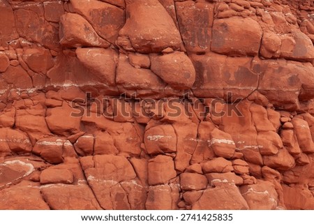 Close up view of lumpy fractured red rock surface