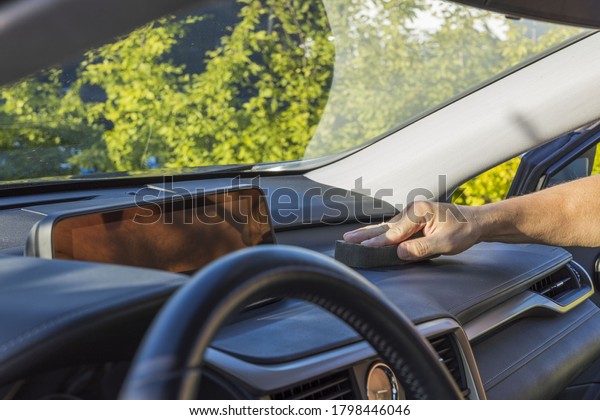 Close up
view of male hand polishing inside of car.
