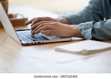 Close up view male hands writes on laptop. Entrepreneur man sit at desk work on modern wireless notebook, do remote telecommute, search information on internet, professional application usage concept