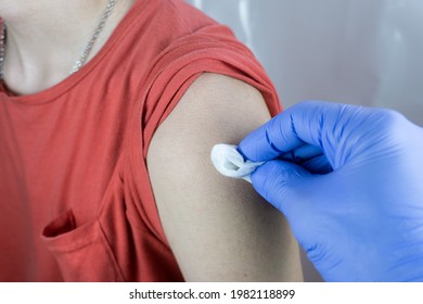 Close Up View Of A Male Nurse Cleaning A Teenage Boy With Cotton Wool, Covid-19 Vacination