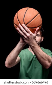 close up view of man going to throw basketball ball isolated on black
