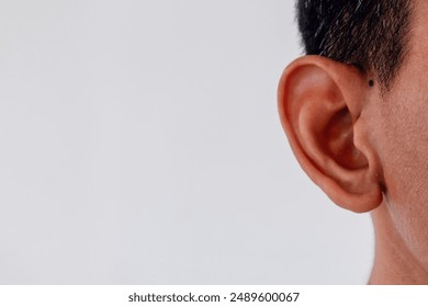 Close up view of a man's ear on white background. Copy space. - Powered by Shutterstock