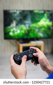 Close up view of man's hands with controller for playing video game
