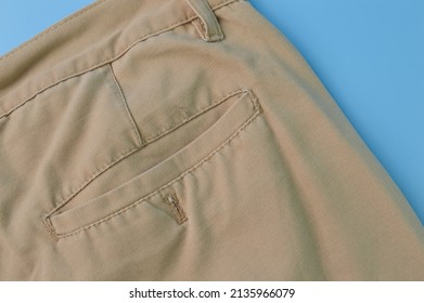 Close Up View Of A Man's Pant Pocket Isolated On A Blue Background