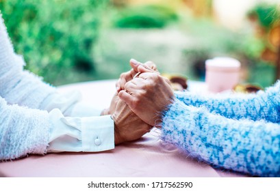 Close Up View Of Mature Couple Holding Hands, Loving Caring Elderly Man Supporting Senior Middle Aged Woman Giving Psychological Empathy And Understanding In Marriage, Getting Older Together Concept.
