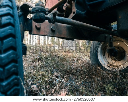Close view of mechanical linkage and aged metal textures.