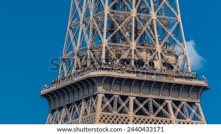 Close up view of middle section of the Eiffel Tower with tourists on observation deck timelapse in Paris, France. People enjoying the view of the city from above