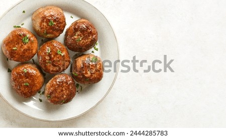 Close up view of minced pork and beef cutlets on plate over white background with free space. Top view, flat lay