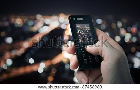 close up view of  mobile phone taking picture on color back