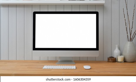 Close Up View Of Mock Up Desktop Computer With Ceramic Decorations On Wooden Table With Plank Wall Background