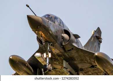 Close Up View Of A Modern Military Armed Fighter Jet Plane Taking Off.