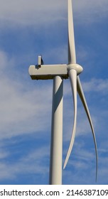 Close up view of the motor and rotor blades on a wind turbine against a blue sky on a wind farm in South Australia 