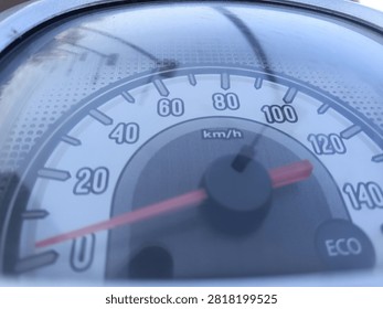 Close up view of motorcycle analog speedometer dashboard with needle