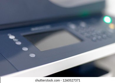 Close up view for a multifunction printer or copier at office. Display and buttons. Selective focus. Blurred image for design or background