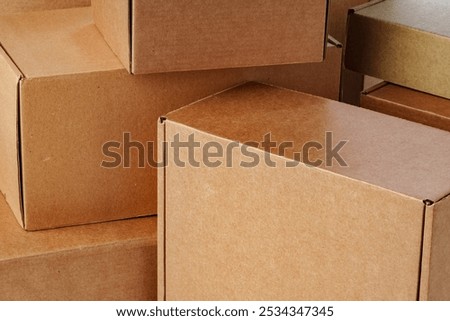 A close view of multiple brown cardboard boxes stacked closely in a warehouse