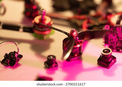 close up view of multiple fpv drone parts such as motors, propellers, and cameras, showcasing intricate details and vibrant colors on a workbench, neutral background, clear negative space, clean