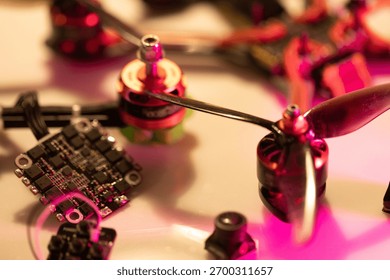 close up view of multiple fpv drone parts featuring motors, propellers, and electronic circuit boards, showcasing intricate details and vibrant colors, neutral background, clear negative space