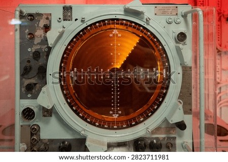 Close view of a naval radar screen preserved as a museum display inside HMS Belfast in London, England.