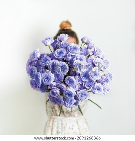 Close up view of nice delicate purple bouquet or bunch with violet roses. Demonstrating color of 2022 year very peri in floristic and wedding. Live bouquet of violet roses for valentines day