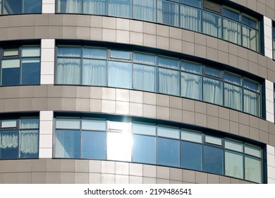 Close Up View To Office Skyscraper Windows, High Business Building Windows With Sunlight Glare. Multistory Still Glass Building With Open Space Office Premises For Rent