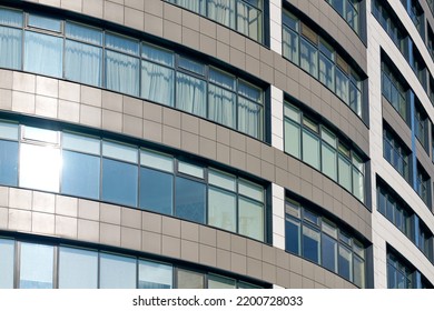 Close Up View To Office Skyscraper Windows, High Business Building Windows With Sunlight Glare. Multistory Still Glass Building With Open Space Office Premises For Rent