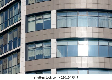 Close Up View To Office Skyscraper Windows, High Business Building Windows With Sunlight Glare. Multistory Still Glass Building With Open Space Office Premises For Rent