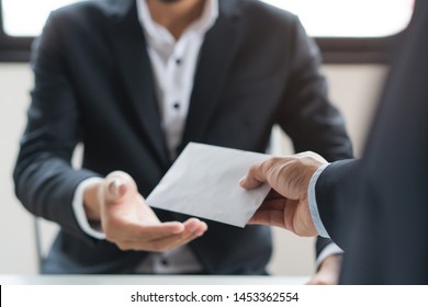Close up view of  office worker receiving salary from boss. - Shutterstock ID 1453362554