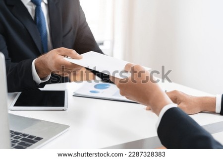 Close up view of office worker receiving salary from boss.