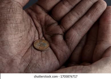 Close Up View Of Old 2 Euro Cent Coin In Dirty Cupped Hands Of Homeless Man. Theme Of The Onset Of The Economic Crisis.