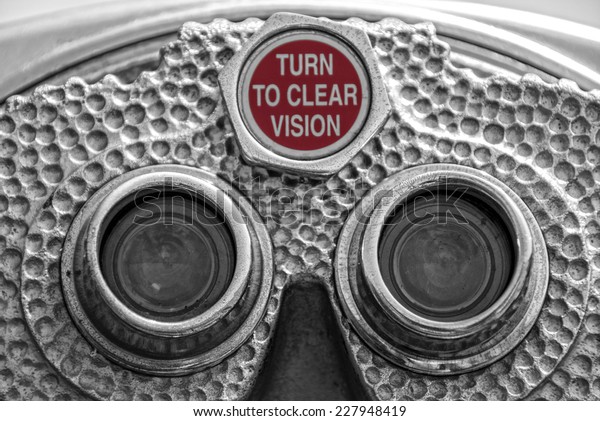 Up close view of old coin-operated\
binoculars with the words: Turn to Clear\
Vision